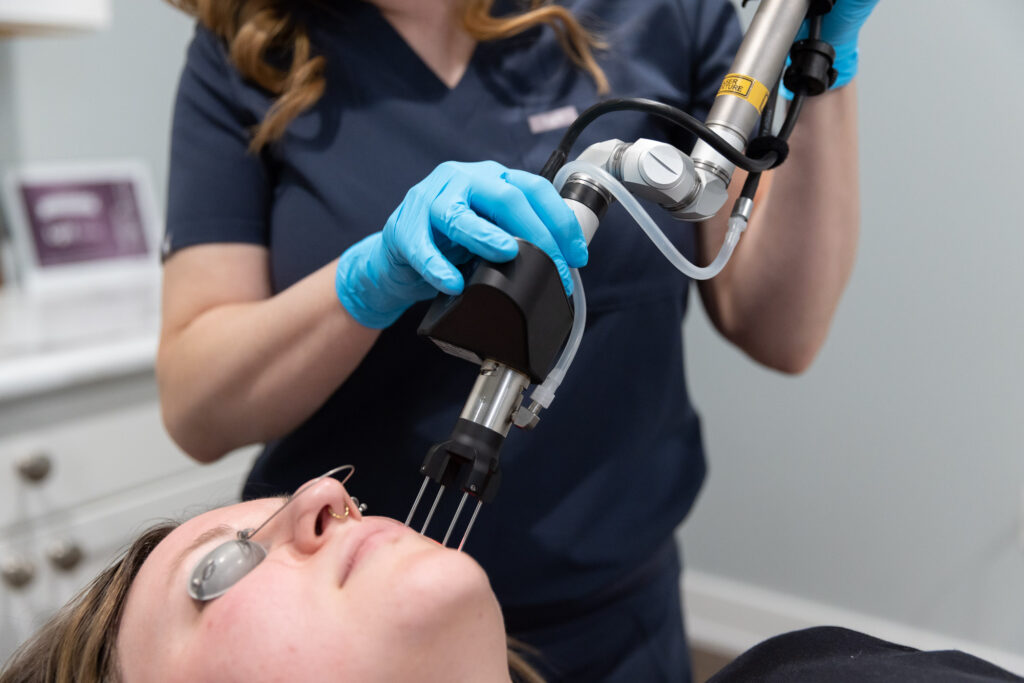 A laser technician applies a CoolPeel in Toledo to a young female patient