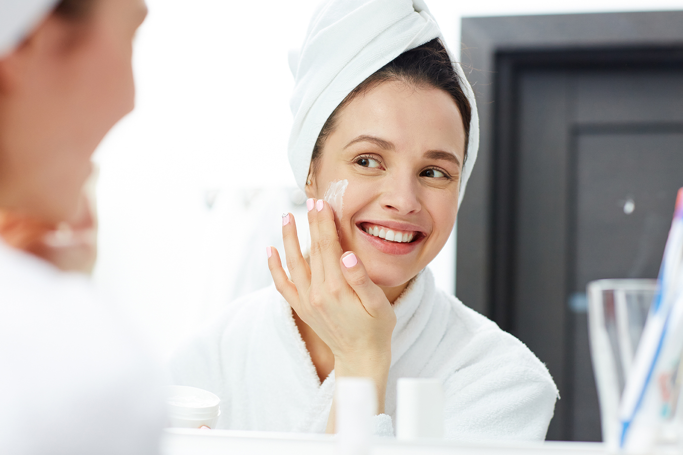 A woman takes care of her skin following a Radiesse treatment