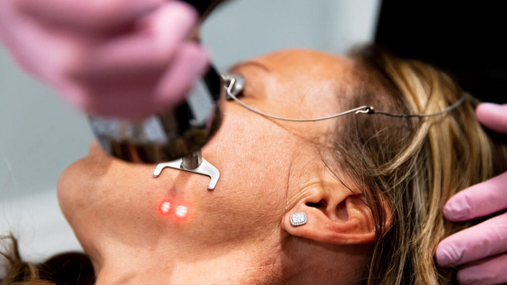 A practitioner performs a treatment at a laser clinic near me