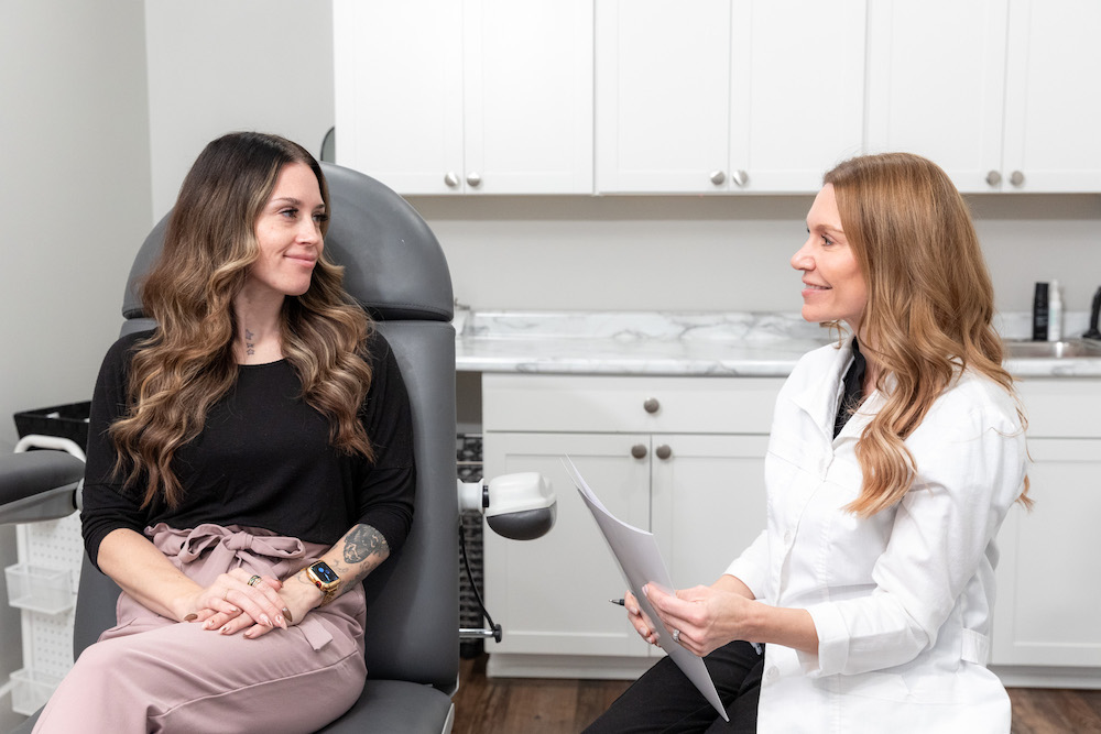 Provider educating patient about types of laser treatments in Ottawa Hills.