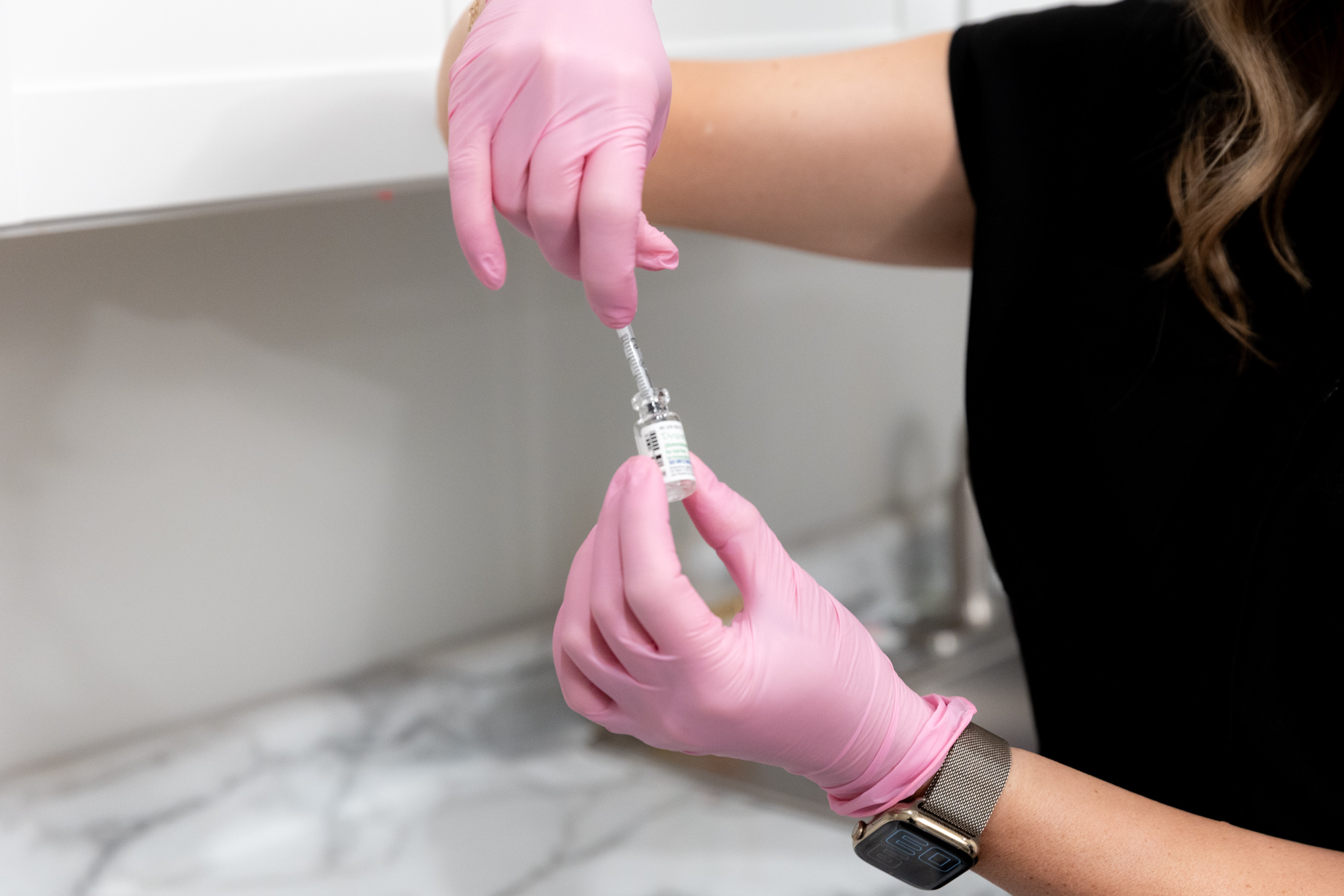 A professional with pink gloves prepares a syringe with Botox for hyperhidrosis in Perrysburg